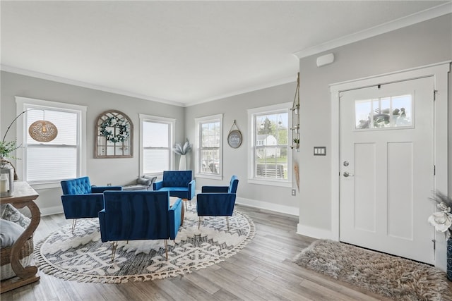 living room with crown molding, baseboards, and wood finished floors