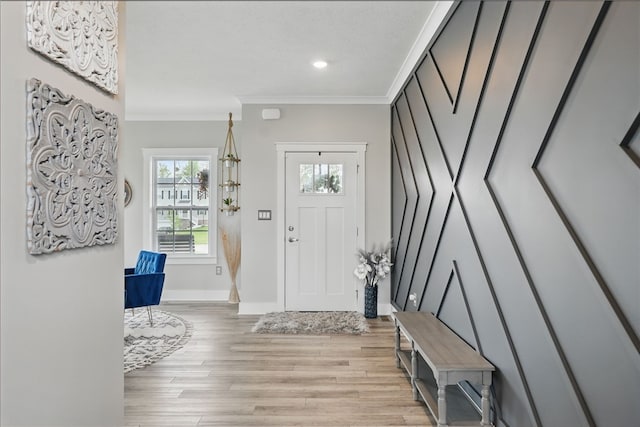 entrance foyer featuring crown molding, light wood-style flooring, baseboards, and recessed lighting
