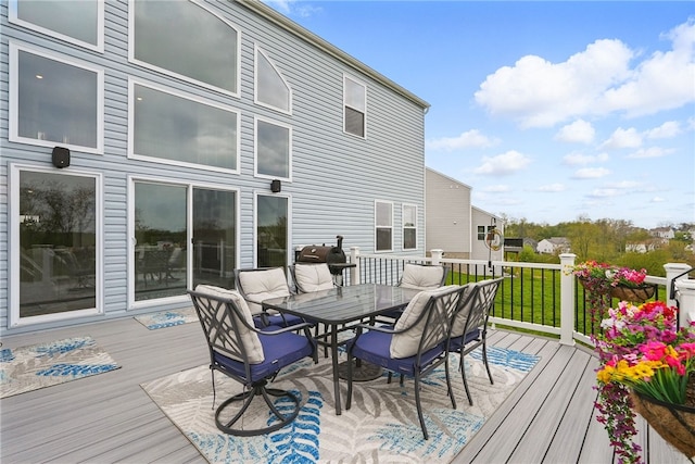 wooden deck featuring outdoor dining space and area for grilling