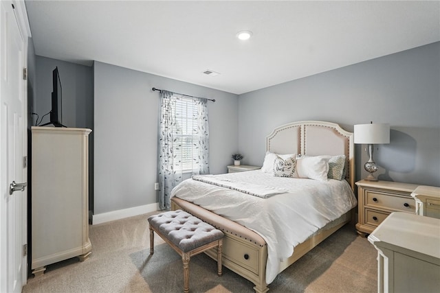 carpeted bedroom featuring baseboards and recessed lighting