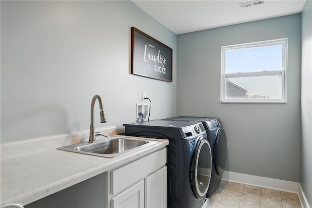 washroom with separate washer and dryer, baseboards, and cabinet space
