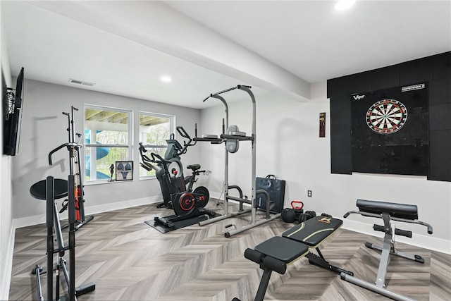 exercise room featuring baseboards and recessed lighting