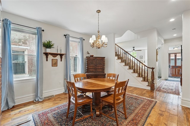 dining space with stairway, a chandelier, light wood-style flooring, recessed lighting, and baseboards