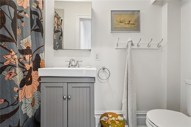 bathroom featuring toilet and vanity