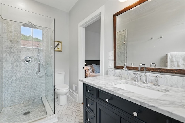 bathroom featuring a stall shower, toilet, vanity, ensuite bathroom, and tile patterned flooring