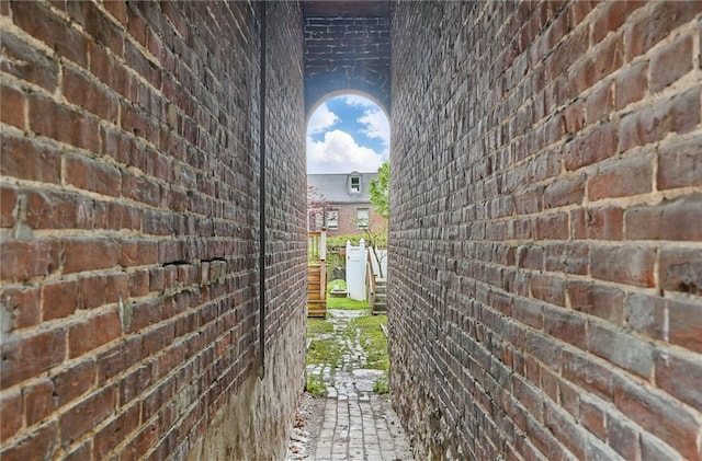 view of property exterior with brick siding