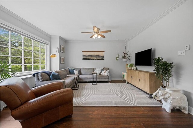 living area featuring a ceiling fan, wood finished floors, ornamental molding, and baseboards