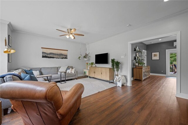 living room featuring wood finished floors, a ceiling fan, crown molding, baseboards, and recessed lighting