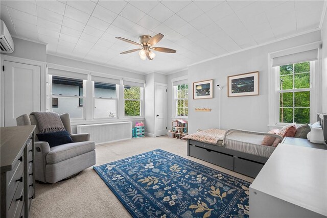 carpeted living room featuring radiator heating unit, a ceiling fan, and ornamental molding