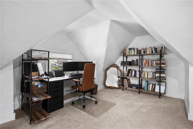 carpeted home office featuring lofted ceiling, a baseboard radiator, and baseboards