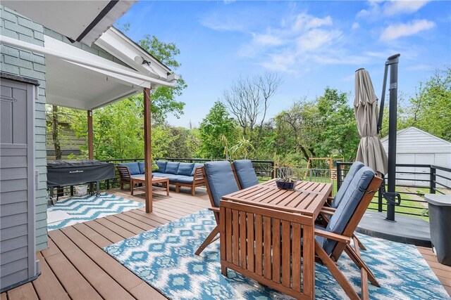 deck featuring an outdoor hangout area, outdoor dining area, grilling area, and an outdoor structure