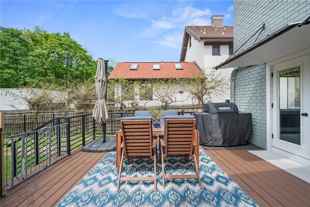 wooden terrace with grilling area and fence