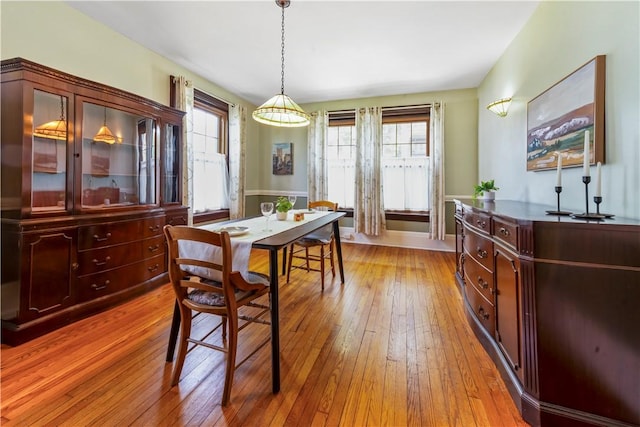 dining room with light wood finished floors and baseboards