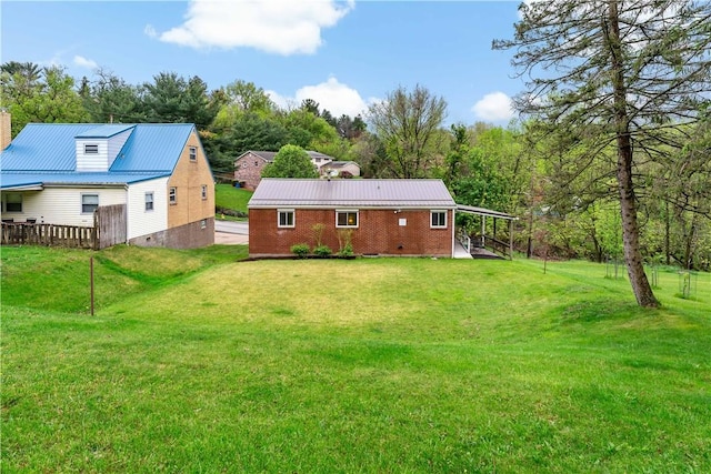 back of house with a yard and brick siding