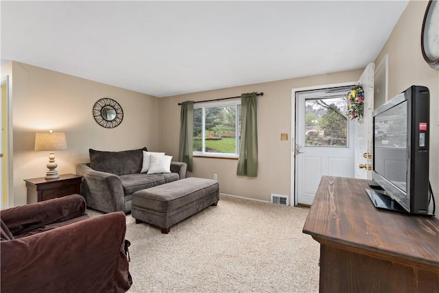 carpeted living room with baseboards