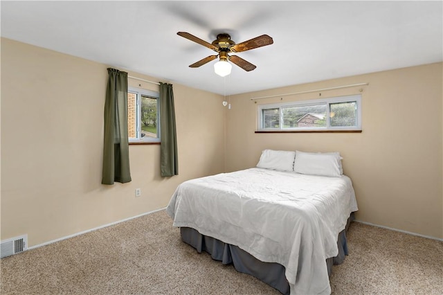 bedroom with carpet, multiple windows, and baseboards