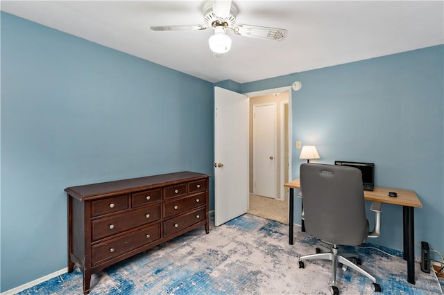 office area featuring a ceiling fan, light carpet, and baseboards