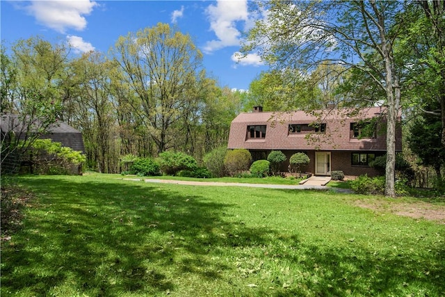 108 Crestview Dr, Evans City Boro, PA 16033 - view of front of house featuring a gambrel roof, a front yard, and a chimney