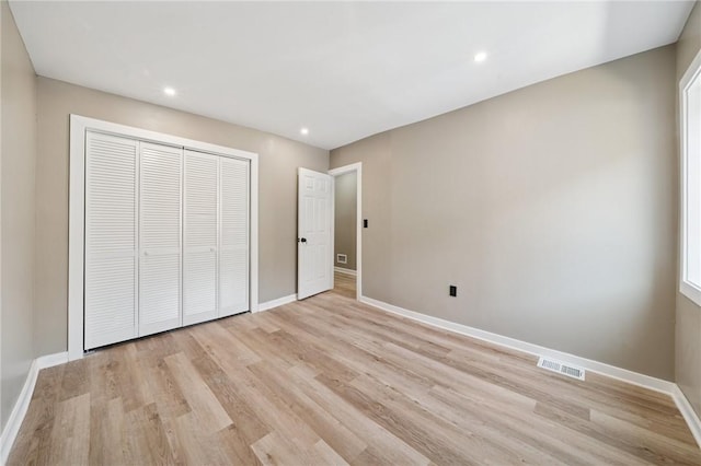 232 57th St, Lawrenceville, PA 15201 - unfurnished bedroom featuring light wood-style flooring, a closet, baseboards, and recessed lighting