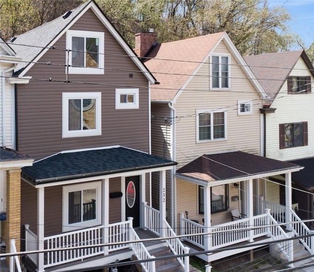 232 57th St, Lawrenceville, PA 15201 - view of front of house with a porch, a chimney, stairway, and a shingled roof