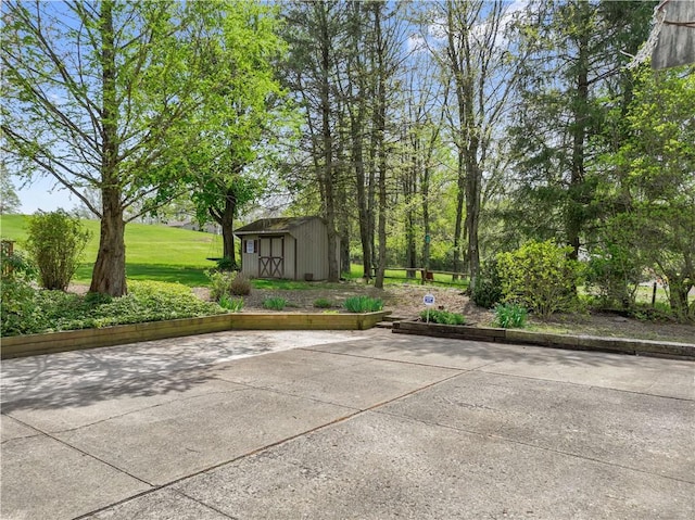view of patio featuring a storage shed and an outbuilding