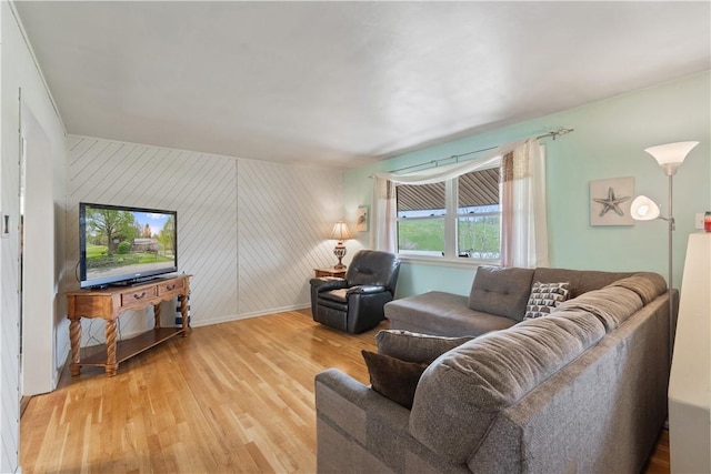 living area featuring light wood-type flooring and baseboards