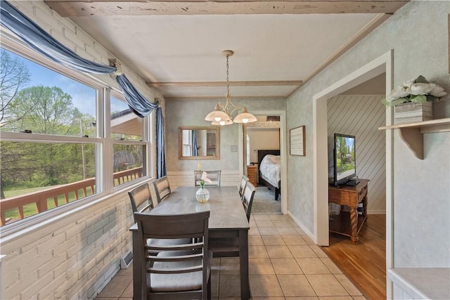 dining area featuring a chandelier and light tile patterned floors