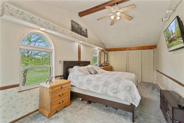bedroom with a closet, light colored carpet, a ceiling fan, and wallpapered walls