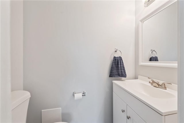 bathroom with toilet and vanity