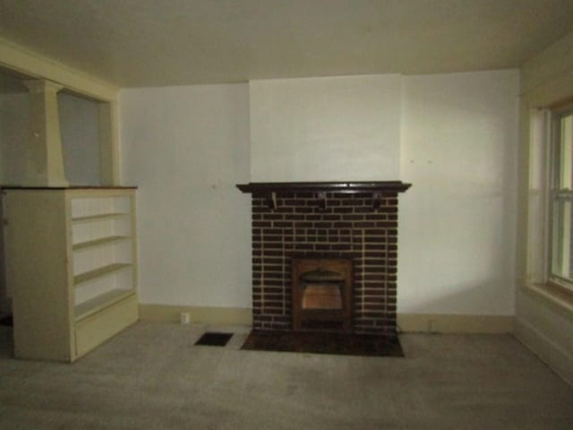 unfurnished living room with baseboards