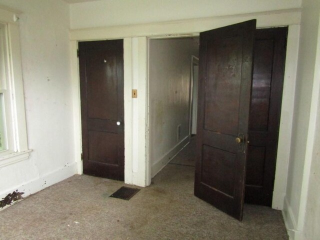 unfurnished bedroom featuring carpet floors and a closet