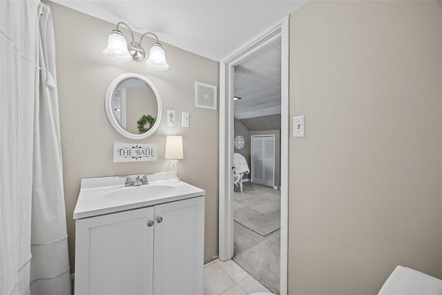 bathroom featuring vanity, a chandelier, and tile patterned floors