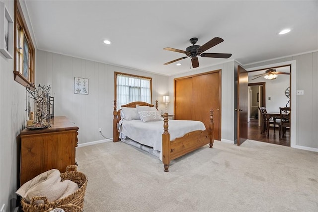 bedroom featuring light colored carpet, recessed lighting, crown molding, baseboards, and ceiling fan