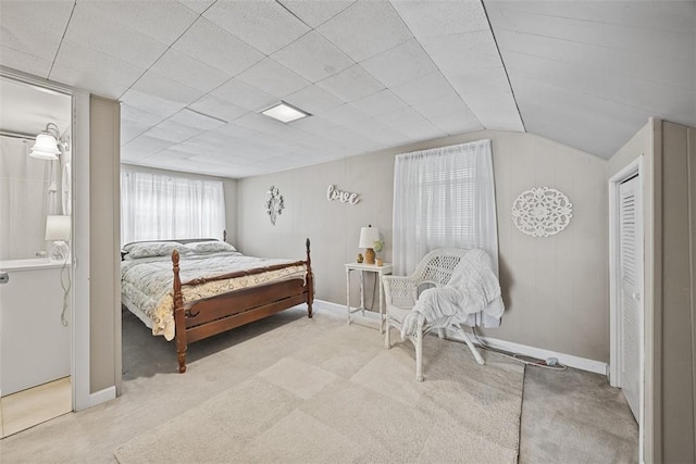 bedroom featuring carpet, baseboards, and lofted ceiling