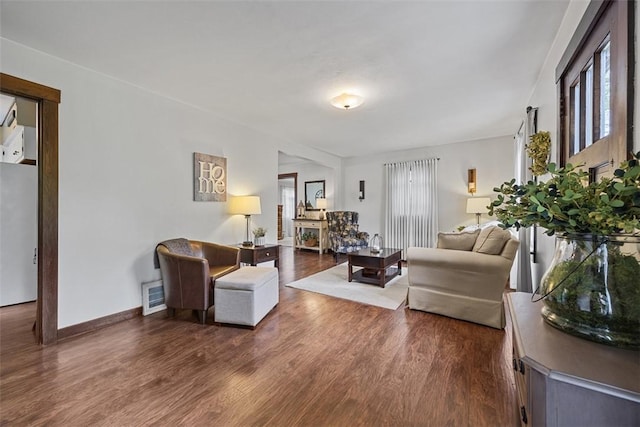 living area featuring dark wood-style floors and baseboards