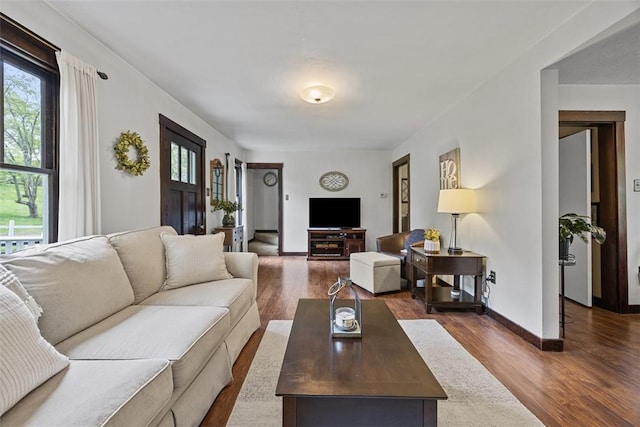 living area with dark wood finished floors and baseboards