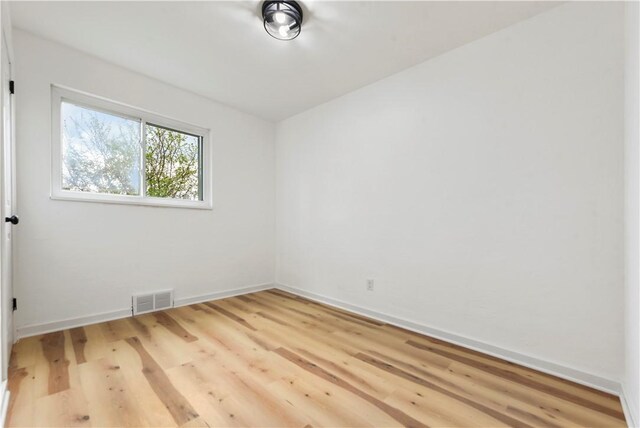 unfurnished room with wood finished floors and baseboards