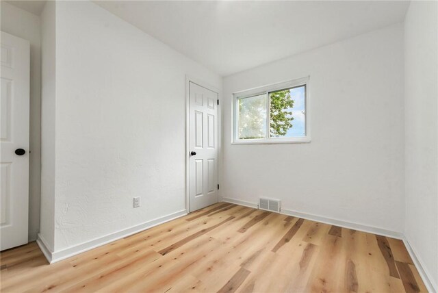 unfurnished room featuring wood finished floors and baseboards