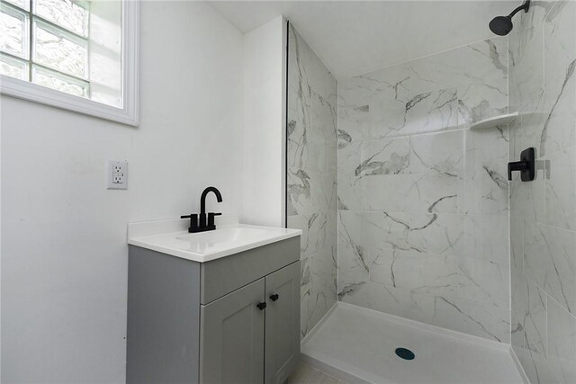 bathroom featuring a stall shower and vanity