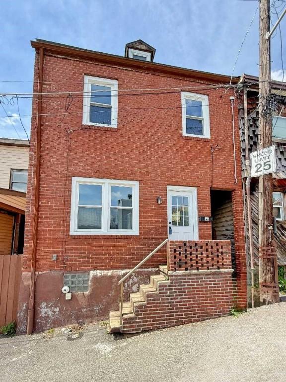 view of property with brick siding