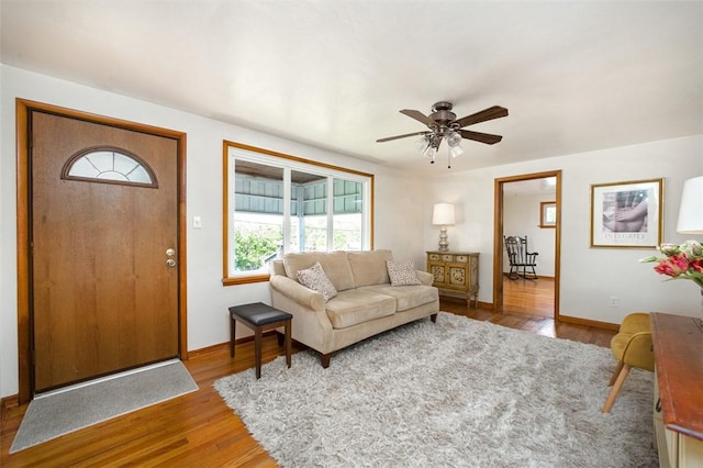 1104 Bennett Ave, Jeannette, PA 15644 - living room with wood finished floors, a ceiling fan, and baseboards