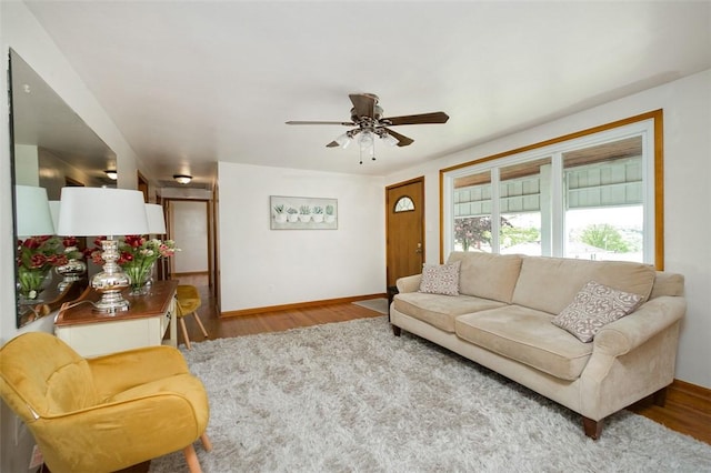 1104 Bennett Ave, Jeannette, PA 15644 - living area featuring wood finished floors, a ceiling fan, and baseboards