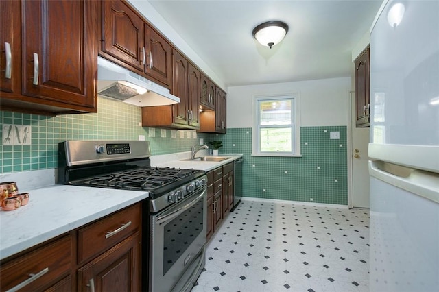 1104 Bennett Ave, Jeannette, PA 15644 - kitchen with appliances with stainless steel finishes, under cabinet range hood, a sink, light floors, and light stone countertops