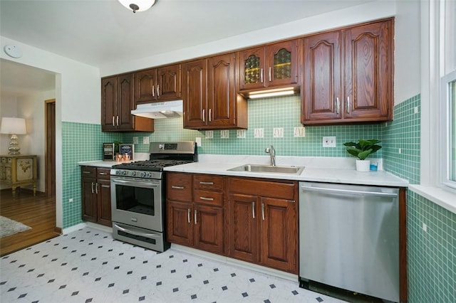 1104 Bennett Ave, Jeannette, PA 15644 - kitchen with appliances with stainless steel finishes, under cabinet range hood, a sink, light countertops, and light flooring