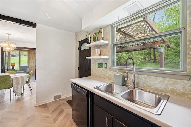 kitchen featuring black dishwasher, a sink, light countertops, a chandelier, and open shelves