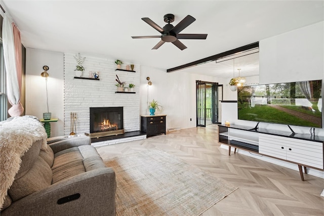 living area with ceiling fan and a brick fireplace