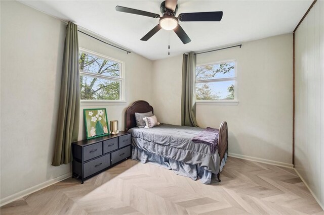bedroom with baseboards and a ceiling fan