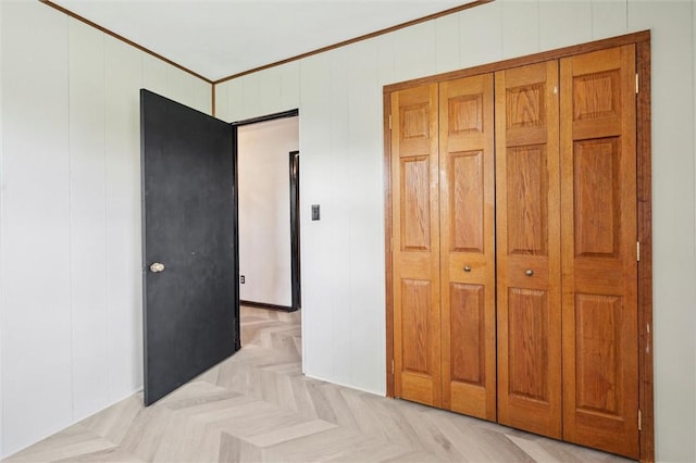 unfurnished bedroom with crown molding and a decorative wall