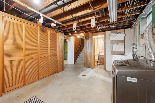 unfinished below grade area with stairway and separate washer and dryer