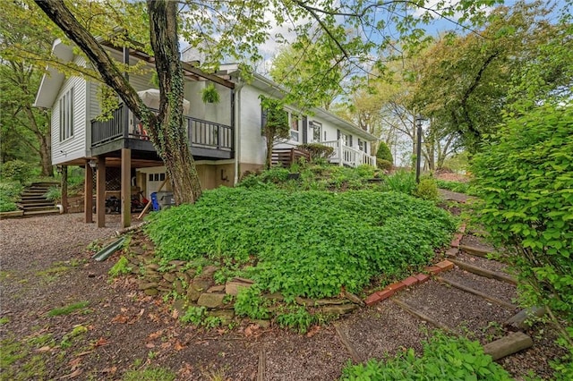 view of yard featuring a deck and stairs